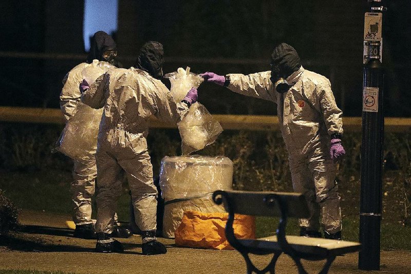 Investigators in protective suits work Tuesday at the Maltings shopping center in Salisbury, England, near where a nerve agent was used to poison former spy Sergei Skripal and his daughter.