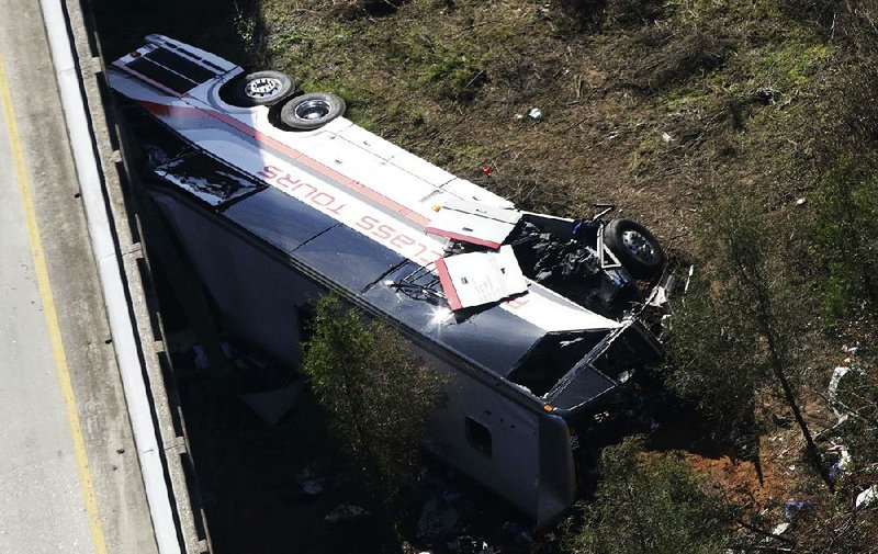 First responders used ropes to reach this charter bus after it crashed into a ravine Tuesday near Loxley, Ala.