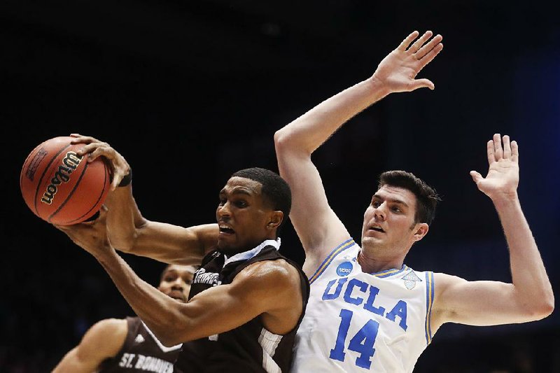 St. Bonaventure’s Idris Taqqee (left) rebounds against UCLA’s Gyorgy Goloman during the first half Tuesday night in a NCAA First Four game in Dayton, Ohio. The Bonnies got 26 points from Courtney Stockard and defeated the Bruins 65-58 to earn their first NCAA Tournament victory since 1970. St. Bonaventure will play Florida on Thursday night in Dallas.