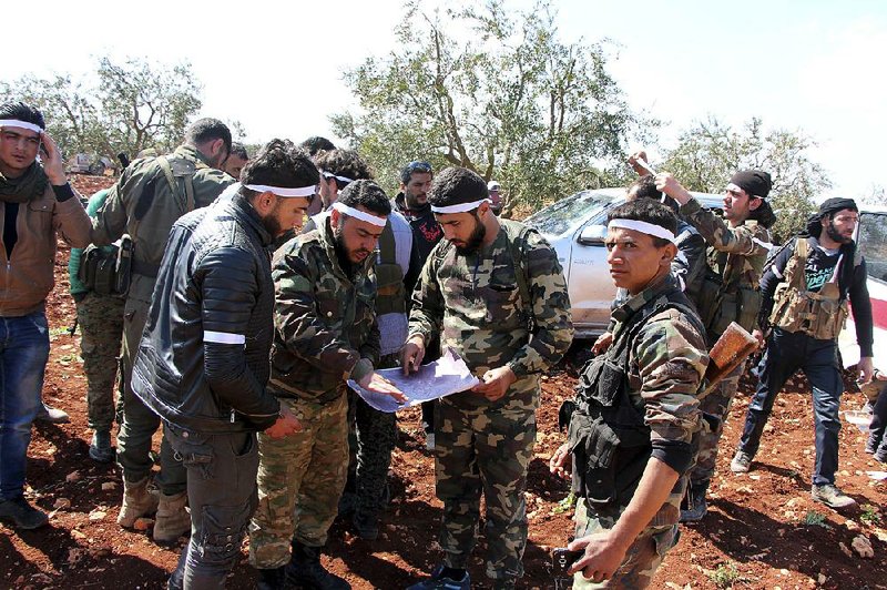 Turkey-backed Free Syrian Army fighters advance Tuesday in the village of Der Mismis southeast of Afrin, Syria. Turkish troops and allied Syrian opposition fighters have laid siege to Syrian Kurdish-held Afrin, the Turkish military says.