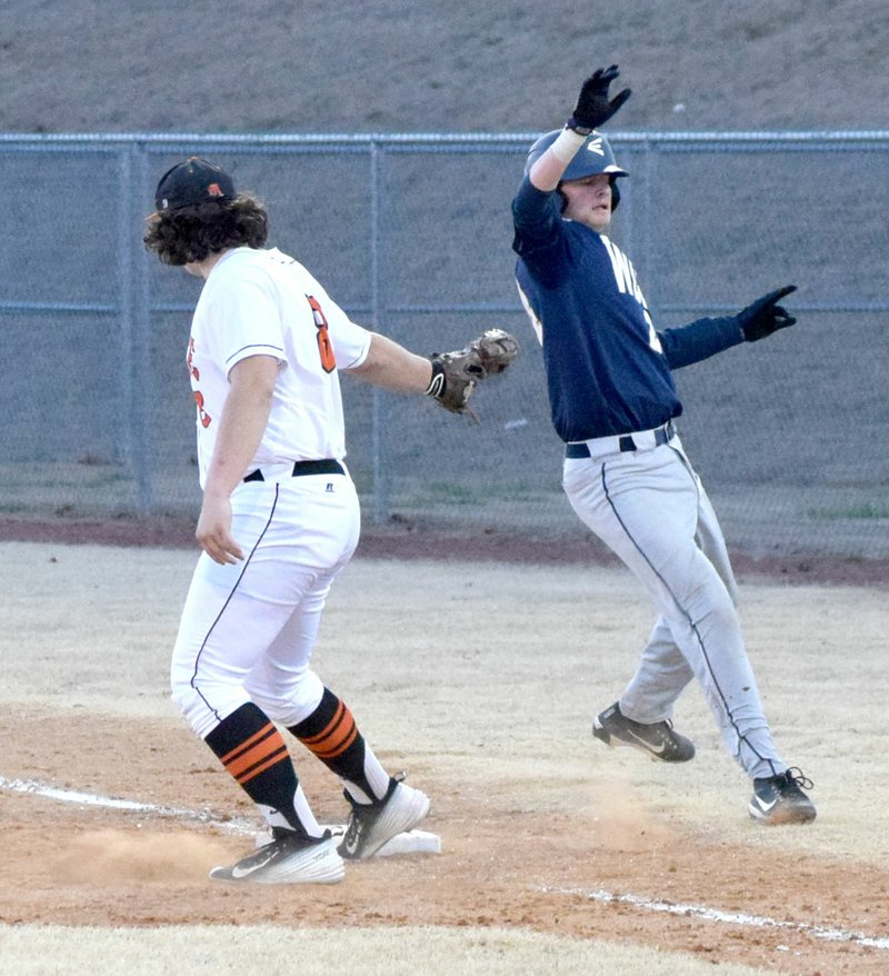 Westside Eagle Observer/MIKE ECKELS Bailey Soule (Gravette 8) tags out a Wolverine runner at first base during the Gravette-Bentonville West baseball contest at Lion Baseball Field in Gravette March 5.