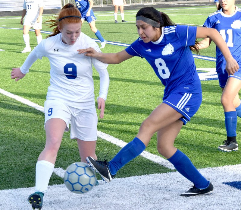 Westside Eagle Observer/MIKE ECKELS Heidi Rubi (Decatur 8) steals the ball away from a Lady Mountie during the first half of the Rogers-Decatur girls' soccer match at Mountie Stadium in Rogers March 8. Rogers took the victory, 7-0, over Decatur in a non-conference matchup.