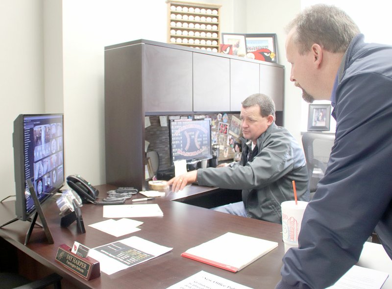 LYNN KUTTER ENTERPRISE-LEADER Jay Harper, Farmington High School dean of students, and Assistant Principal Clayton Williams watch monitors to see where an "active shooter" is in the school. This was used to give information to students and teachers in their rooms and was part of an exercise Thursday morning conducted by Farmington Police Department and other law enforcement officials.