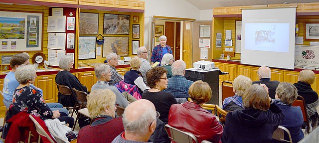 Keith Bryant/The Weekly Vista Jeanne Stokebrand with the Questers discusses internment camps for people of Japanese descent with visitors at the Bella Vista Historical Museum.