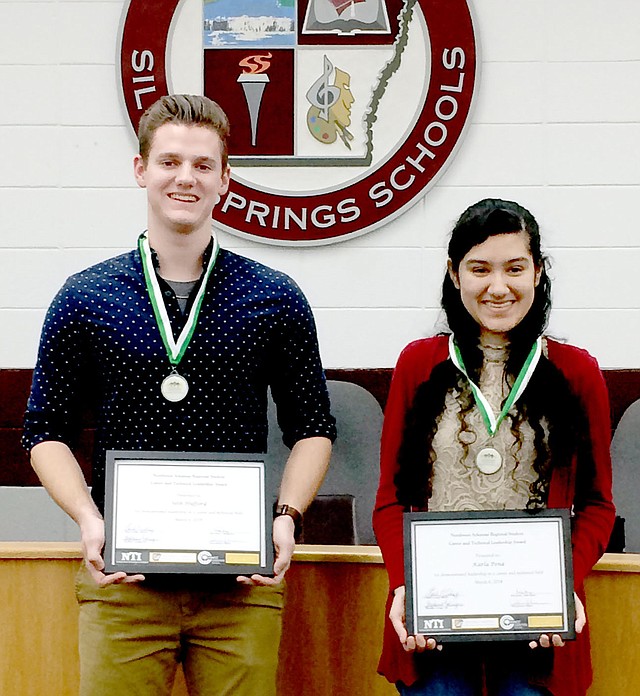 Janelle Jessen/Herald-Leader High school seniors Seth Hufford and Karla Pena were recognized at the March 8 school board meeting for receiving the Northwest Arkansas Regional Student Career &amp; Technical Leadership Award. Both recipients received the award at the Northwest Arkansas Regional Career Day in February and are eligible to receive a $1,000 scholarship from the Northwest Arkansas Community College or a one semester tuition waiver from Northwest Technical Institute upon high school graduation. Pena is a completer in business and family consumer sciences and is involved in FCCLA and FBLA. She will be attending FCCLA nationals in June to compete in the early childhood division. She attended FCCLA nationals as a junior and competed in entrepreneurship. She is a member of the Arvest Junor Bank Board and plans to attend NWACC in the fall to major in business administration. Hufford is a completer in plant and animal science. He is involved in FFA and shows hogs at the county fair through FFA. He will attend NWACC this fall with intentions of transferring to the University of Arkansas after two years to major in poultry science with a minor in agribusiness.