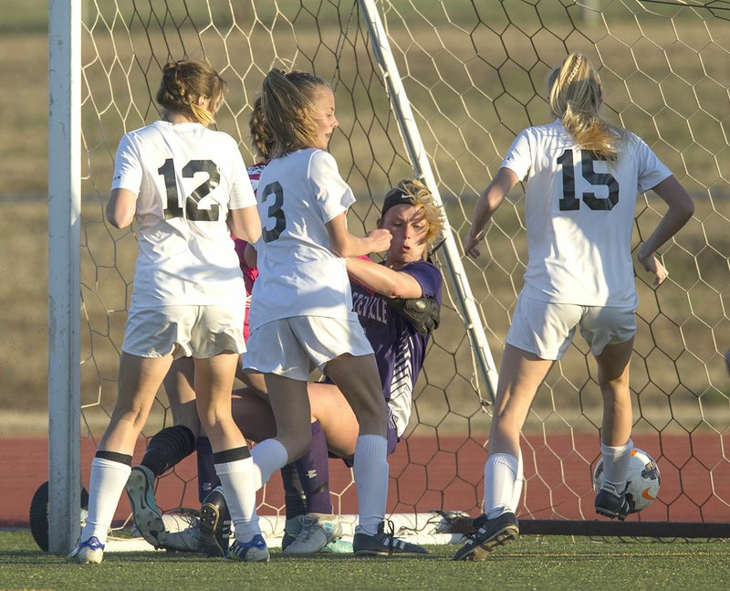 NWA Democrat-Gazette/BEN GOFF @NWABENGOFF Ginger Olson (3) of Bentonville High watches her shot go into the net past Fayetteville keeper Payton Woodward (bottom center) after a rebound Tuesday at Bentonville's Tiger Athletic Complex.
