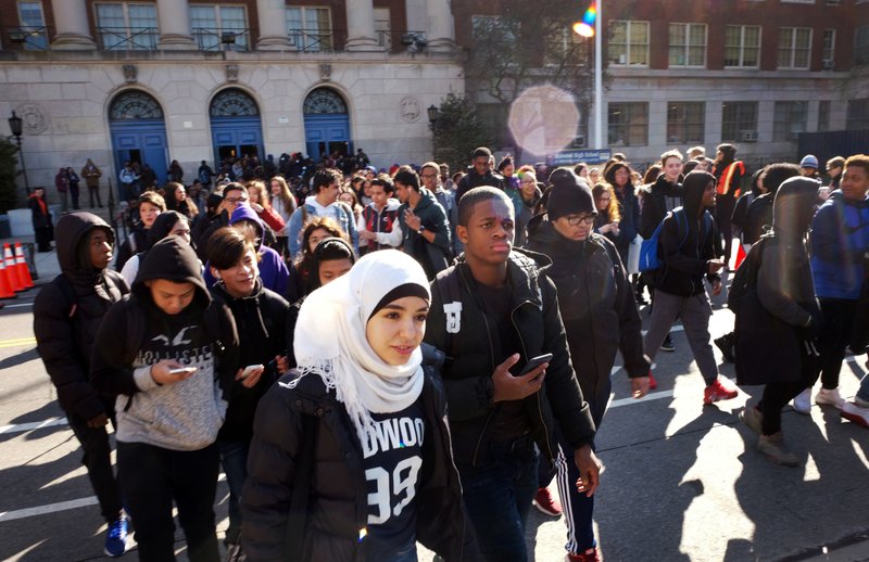 Hundreds of students walk out of Midwood High School as part of a nationwide protest against gun violence, Wednesday, March 14, 2018, in the Brooklyn borough of New York. It is the nation's biggest demonstration yet of the student activism that has emerged in response to last month's massacre of 17 people at Florida's Marjory Stoneman Douglas High School. (AP Photo/Mark Lennihan)

