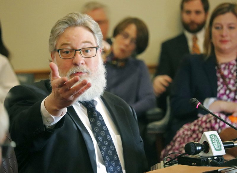 Michael McAlister, the managing attorney at the Arkansas Department of Environmental Quality, gestures while testifying before the Senate Public Health, Welfare and Labor Committee at the state Capitol on Wednesday, March 14, 2018. 