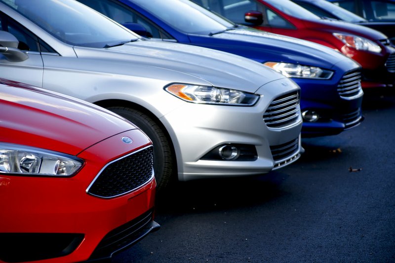 In this Nov. 19, 2015, photo, a row of new Ford Fusions are for sale on the lot at Butler County Ford in Butler, Pa. 