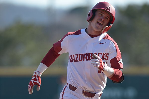 Arkansas third baseman Casey Martin smiles as he rounds third after hitting a solo home run against Texas Wednesday, March 14, 2018, during the second inning at Baum Stadium in Fayetteville.