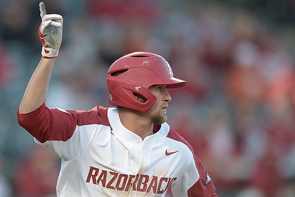 Arkansas infielder Hunter Wilson reacts to hitting an RBI single during the eighth inning of a game against Texas on Wednesday, March 14, 2018, in Fayetteville. 
