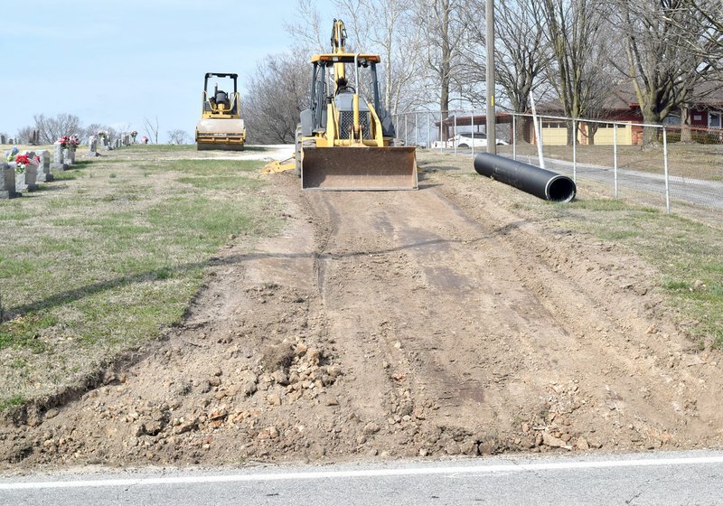 A backhoe and roller machines laid the foundation for a new street at the Decatur Cemetery on March 9. Once completed, this road will serve as a one-way entrance to the cemetery and Setser Street will become the exit.

