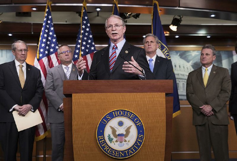 Rep. John Rutherford, flanked by Reps. Mike Bost (left) and Kevin McCarthy, talks about his school-safety bill Wednesday. The bill is one of two in a White House plan to combat school shootings. 
