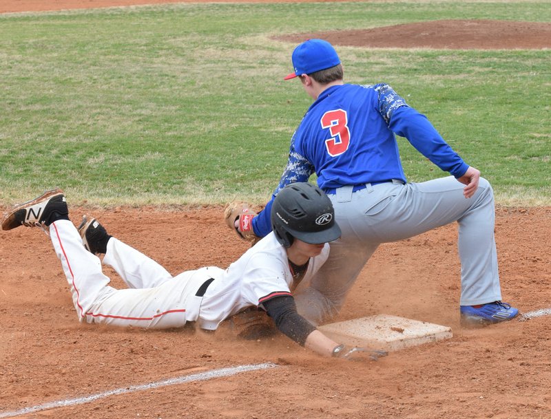 RICK PECK/SPECIAL TO MCDONALD COUNTY PRESS McDonald County's Jordan Platter dives safely into third base during the Mustangs 4-1 win over East Newton in a jamboree held March 10 at MCHS to open the 2018 baseball season.