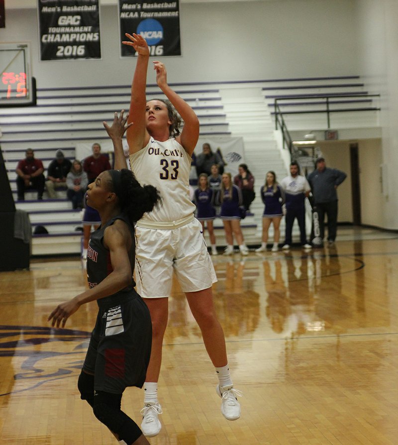 The Sentinel-Record/File photo SMART SHOOTER: Ouachita Baptist senior Kori Bullard (33), of Hot Springs, takes a shot for three over Henderson State sophomore Pink Jones (2), of Fayetteville, during the Battle of the Ravine at Bill Vining Arena on Jan. 24. Bullard was named to the CoSIDA Division II Academic All-America Third Team this week for basketball.