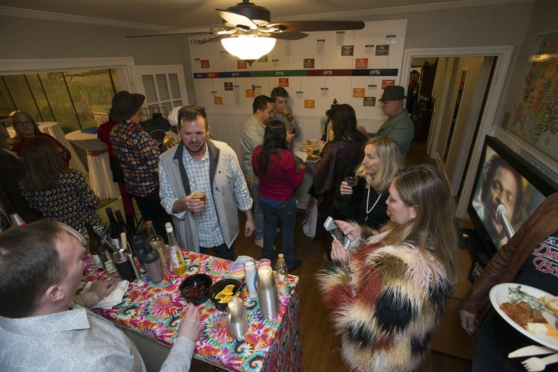 Guests dressed in1970s clothes attend a themed fundraiser Thursday March 8, 2018 at the Clinton House in Fayetteville. The Fayetteville Advertising and Promotion Commission has $20,000 in contributions projected in the budget this year for the museum.