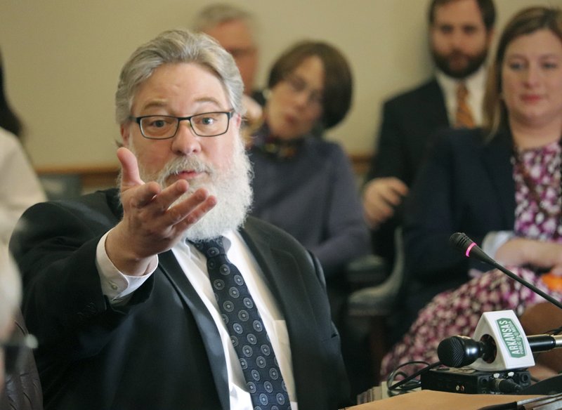 EXPLAINING PROCESS: Michael McAlister, the managing attorney at the Arkansas Department of Environmental Quality, gestures while testifying before the Senate Public Health, Welfare and Labor Committee at the state Capitol on Little Rock, Ark., on Wednesday, March 14, 2018. McAlister was explaining the permit process for Arkansas farms that require a liquid animal waste disposal permit. (AP Photo/Kelly P. Kissel)