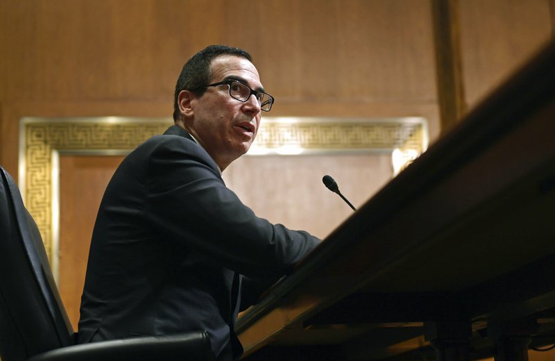 In this Feb. 14, 2018 photo, Treasury Secretary Steven Mnuchin testifies before the Senate Finance Committee on Capitol Hill in Washington. The Trump administration on Thursday imposed sanctions on 19 Russians for alleged interference in the 2016 U.S. presidential election, including 13 indicted by special counsel Robert Mueller as part of his Russia-related investigation.  The Treasury Department announced the sanctions amid withering criticism of Trump and his administration for failing to use the congressionally mandated authority to punish Russia for the election interference. Trump himself has been skeptical of the allegations.  (AP Photo/Susan Walsh)