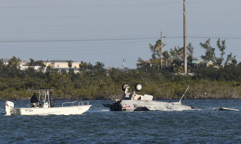 In this March 14, 2018 photo, U.S. Navy personnel respond to a F/A-18 Super Hornet that crashed on its approach to Naval Air Station Key West in Florida. Both the pilot and weapons system officer ejected and were recovered, but U.S. Naval Air Forces reported late Wednesday night that both had died. 