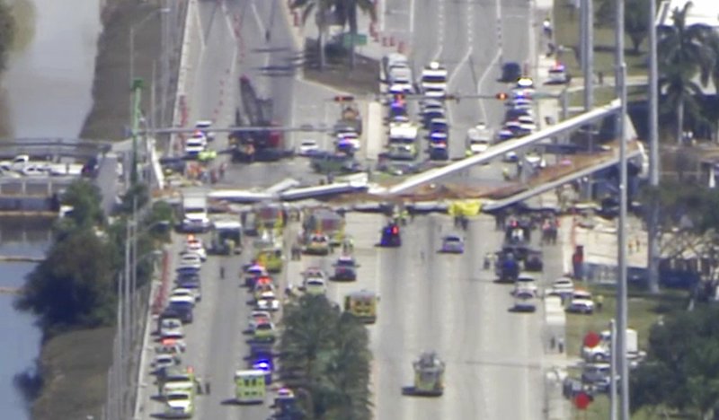 In this frame from video, emergency personnel work at the scene of a collapsed bridge in the Miami area Thursday, March 15, 2018.