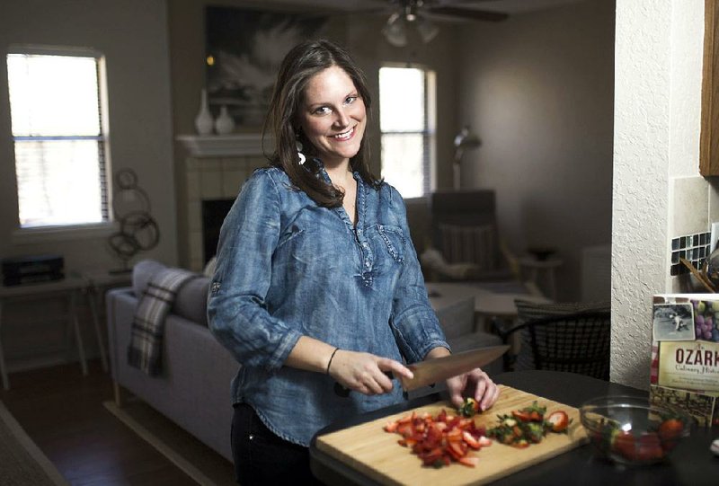 Chef Erin Rowe chops strawberries in her personal space, Thursday, February 8, 2018 at her home in Bella Vista.

