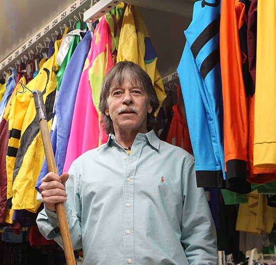The Sentinel-Record/Richard Rasmussen IMPORTANT ROLE: Brent Kelley, silks coordinator at Oaklawn Park, stands with a few of the nearly thousand silks he keeps track of for race days. Silks represent an owner's stable and are worn by jockeys as identifying colors during races.