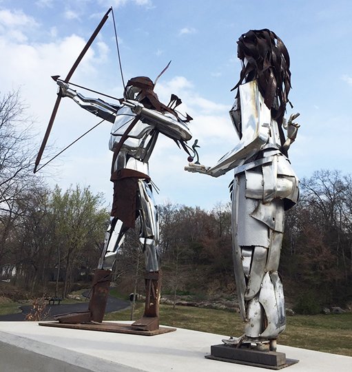 Submitted photo FESTIVAL: Guarding the new butterfly garden along the Greenway Trail are winners of the 2017 Upcycle Sculpture event, "The Indian and Maiden," by John Mark Baker of Baker Fabrication and Welding. The 2018 festival will take place on April 21 from 9 a.m. to 1 p.m. Applications are available at http://www.cityhs.net.