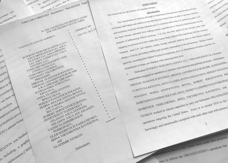 In this March 15, 2018, photo, a portion of the Feb. 16, indictment against Russia's Internet Research Agency is photographed in Washington. In its toughest challenge to Russia to date, the Trump administration accused Moscow of an elaborate plot to penetrate America's electric grid, factories, water supply and even air travel through cyber hacking. The U.S. also hit targeted Russians with sanctions for alleged election-meddling for the first time since President Donald Trump took office. The list of Russians being punished included all 13 indicted last month by special counsel Robert Mueller, a tacit acknowledgement by the Trump administration that Mueller's Russia-related probe has merit. (AP Photo/Jon Elswick)
