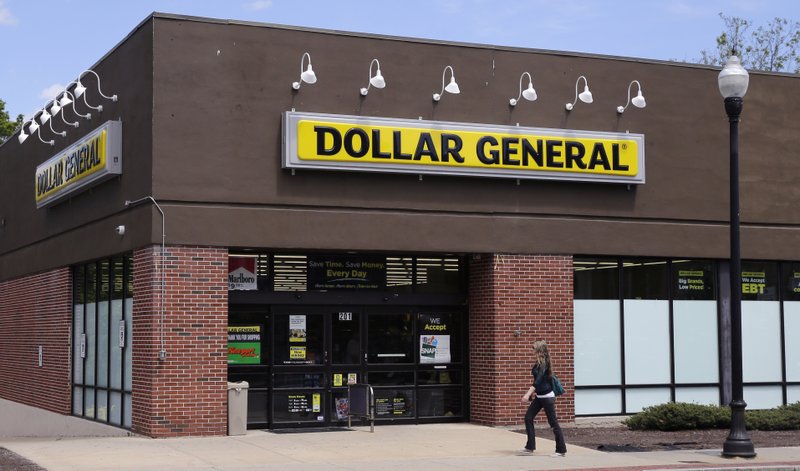 FILE - In this May 18, 2016, file photo, a woman walks past a Dollar General store in Methuen, Mass. Dollar General reports earnings Thursday, March 15, 2018. (AP Photo/Charles Krupa, File)