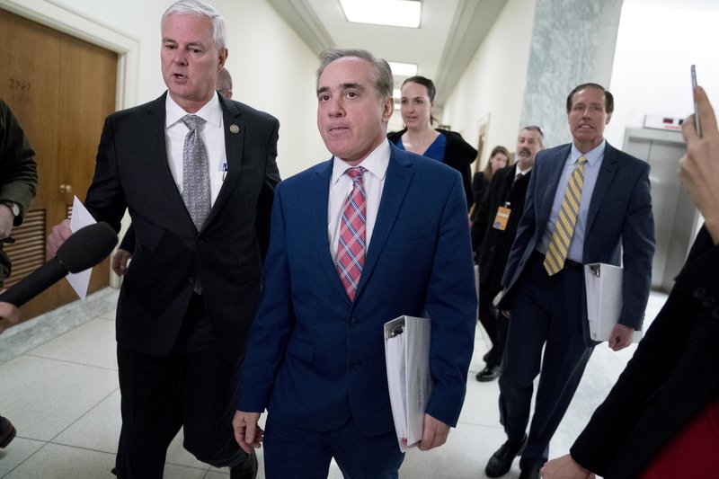 Rep. Steve Womack, R-Ark., left, greets Veterans Affairs Secretary David Shulkin, center, as he arrives for a House Appropriations subcommittee hearing on Capitol Hill in Washington, Thursday, March 15, 2018. (AP Photo/Andrew Harnik)