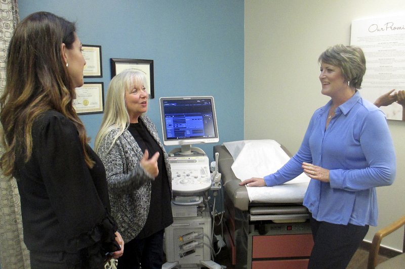 In this Feb. 8, 2018, photo, Blayne Wittig, executive director of Options for Women of California, left, a center in Concord, Calif., Debbie Whittaker, nurse manager, center, and Christine Vatuone, president and CEO of Informed Choices, talk at Informed Choices, a crisis pregnancy center in Grilroy, Calif. A California law regulating anti-abortion pregnancy centers has led to a Supreme Court clash at the intersection of abortion and free speech. The centers say a law requiring them to tell pregnant clients the state has family planning and abortion care available at little or no cost violates the centers’ free speech rights. Informed Choices is what Vatuone describes as a “life-affirming” pregnancy center. Even as it advertises “free pregnancy services” and promises in signs on its door and inside to discuss all options with pregnant women, Informed Choices exists to steer women away from abortion. 