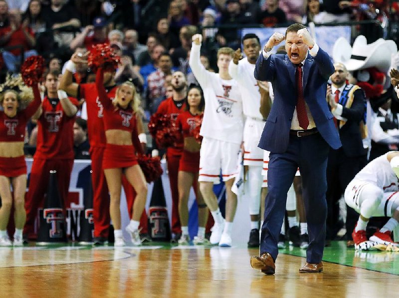 Texas Tech Coach Chris Beard, who formerly coached at UALR, cheers for his team Thursday during the Red Raiders’ 70-60 victory over Stephen F. Austin in the East Region of the NCAA Tournament in Dallas.
