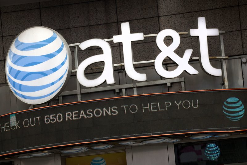 FILE - In this Oct. 24, 2016, file photo, the AT&T logo is positioned above one of its retail stores in New York.  (AP Photo/Mark Lennihan, File)