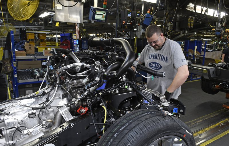 FILE- In this Oct. 27, 2017, file photo, workers assemble Ford trucks at the Ford Kentucky Truck Plant in Louisville, Ky. On Friday, March 16, 2018, the Federal Reserve reports on U.S. industrial production for February. (AP Photo/Timothy D. Easley, File)