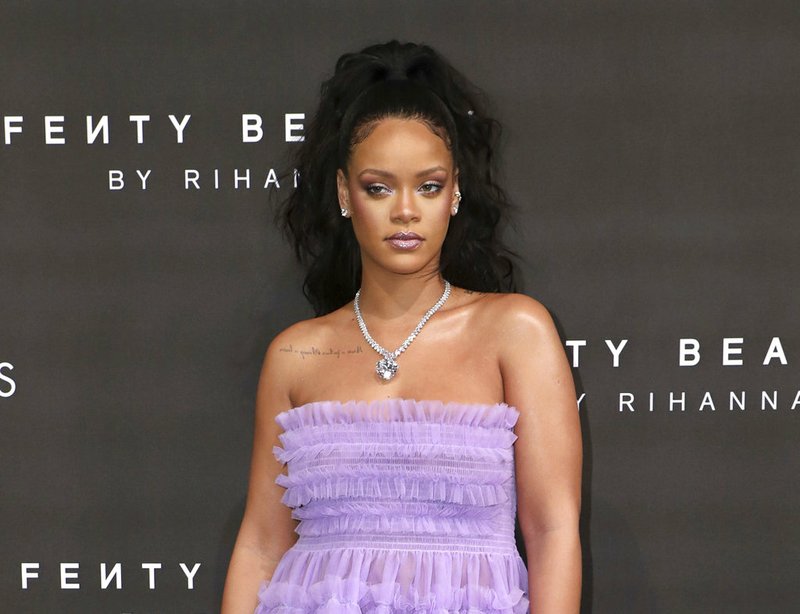 In this Sept. 19, 2017 file photo, singer Rihanna poses for photographers at the Fenty Beauty by Rihanna fashion range launch during London Fashion Week. An ad on Snapchat asking users if they’d rather “Slap Rihanna” or “Punch Chris Brown” has spawned widespread outrage, including from the singer herself. Rihanna, who Brown was convicted of assaulting when she was his girlfriend in 2009, posted a statement on her Snapchat and Instagram accounts saying the ad intentionally brings shame to domestic violence victims. (Photo by Vianney Le Caer/Invision/AP, File)