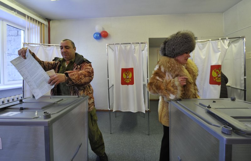 People cast their ballots at a polling station in Yelizovo, about 30 kilometers ( 19 miles) north-east from Petropavlovsk-Kamchatsky, capital of Kamchatka Peninsula region, Russian Far East, Russia, on Sunday, March. 18, 2018. Polls have opened in Russia's Far East for the presidential election in which Vladimir Putin seeks a 4th term. (AP Photo/Alexander Petpov)