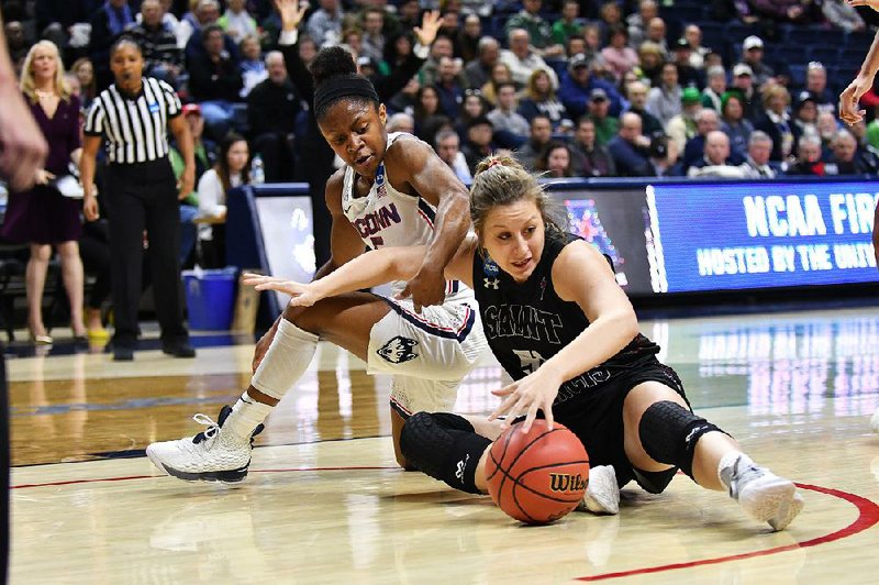 Saint Francis guard Haley Thomas (right) and Connecticut Huskies guard Crystal Dangerfield battle for the loose ball during the Huskies’ 140-52 victory on Saturday in Storrs, Conn.
