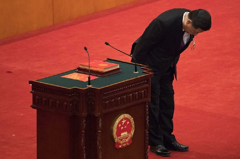 Chinese President Xi Jinping, who was unanimously re-elected to a second term, bows Saturday after taking the oath of office during a plenary session of the National People’s Congress in Beijing’s Great Hall of the People. Xi has no limit on the number of terms he can serve.