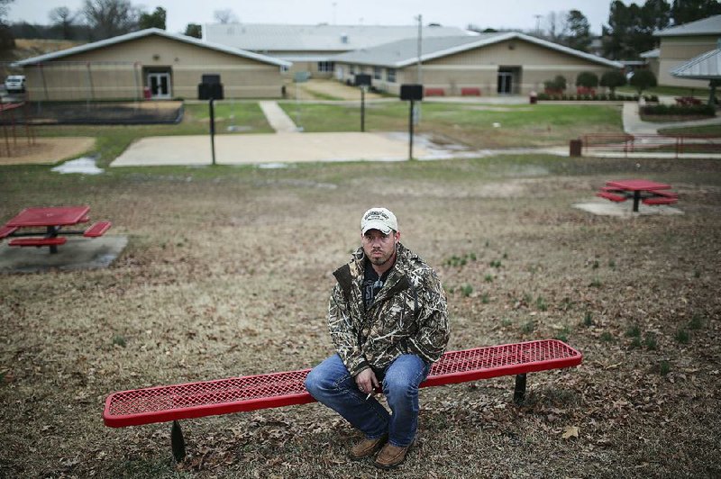 Tristan McGowan sits on the grounds of Westside Middle School in late February. McGowan was a seventh-grader at the school when he was wounded by gunfi re 20 years ago this week. “It felt like a hot iron got stuck beneath my arm,” he said. “I dropped to my knees and started yelling.” Of the five killed and 10 injured, he was the only boy.