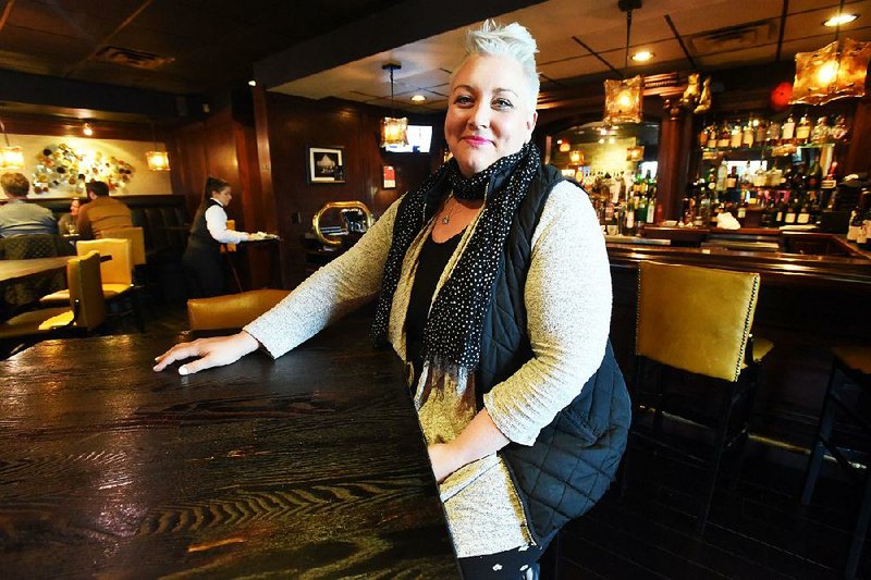 Sharae Allen, seated at the The River Grille Steakhouse in Bentonville, said she hopes to eventually return to work at the restaurant.
