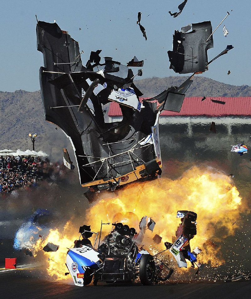 Funny car driver John Force suffers an engine explosion at Chandler, Ariz., on Feb. 28. Force has detonated engines in all three NHRA events this season.
