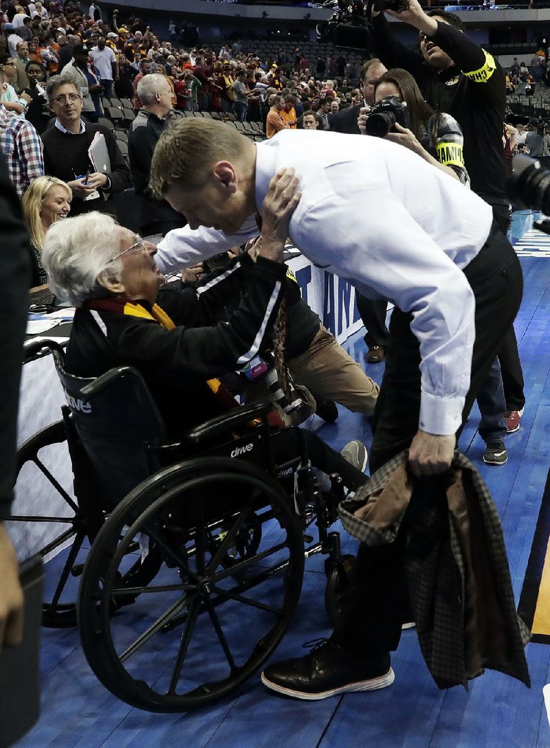 Sister Jean Dolores Schmidt, 98, (left) leads Loyola-Chicago in a team prayer before every game and gives each player a critique based on how well they played. Schmidt has been the Ramblers’ team chaplain since the early 1990s and rarely misses a game.
