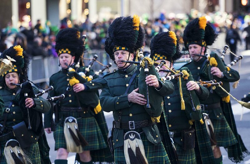 A bagpipe unit representing the state courts marches Saturday at the St. Patrick’s Day parade in New York.