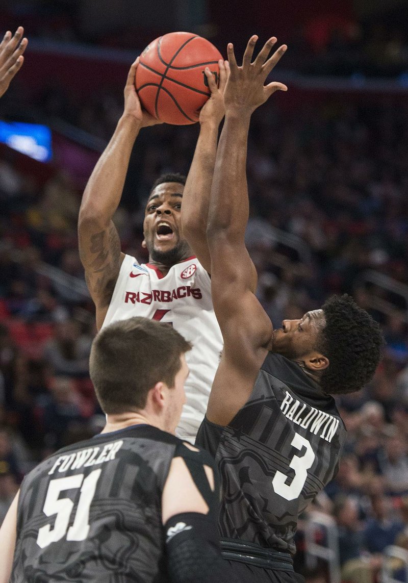 Butler’s Kamar Baldwin (right) defends against a shot by Arkansas Daryl Macon during Friday’s game in Detroit. Butler held Macon, Jaylen Barford and Daniel Gafford — Arkansas’ leading scorers — to 34 points on 9-of-30 shooting. 