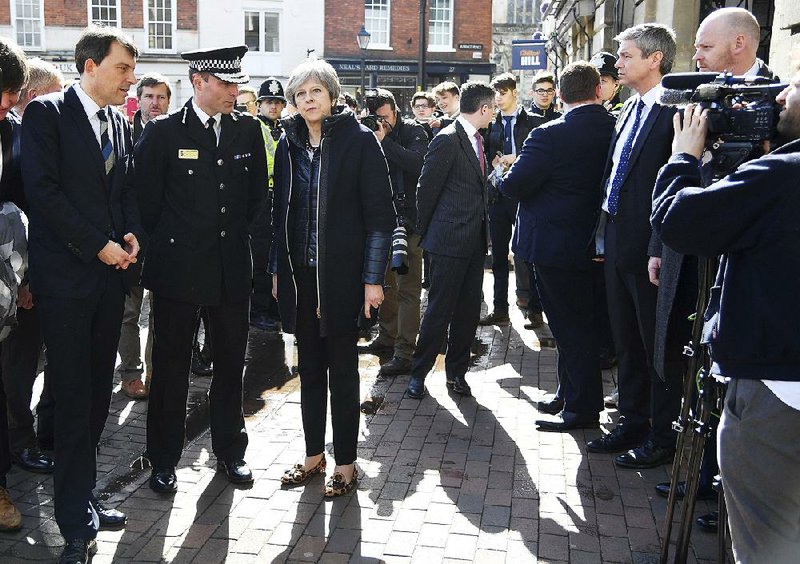 British Prime Minister Theresa May is briefed by police officials earlier this week as she views the  area in Salisbury where former Russian spy Sergei Skripal and his daughter were found after they were poisoned.
