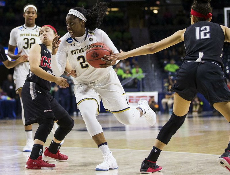 Notre Dame’s Arike Ogunbowale (center) drives between Cal State Northridge’s Hayley Tanabe (left) and Meghann Henderson during a first-round game of the NCAA Women’s Tournament on Friday in South Bend, Ind. Ogunbowale scored 30 points as Notre Dame won 99-81.
