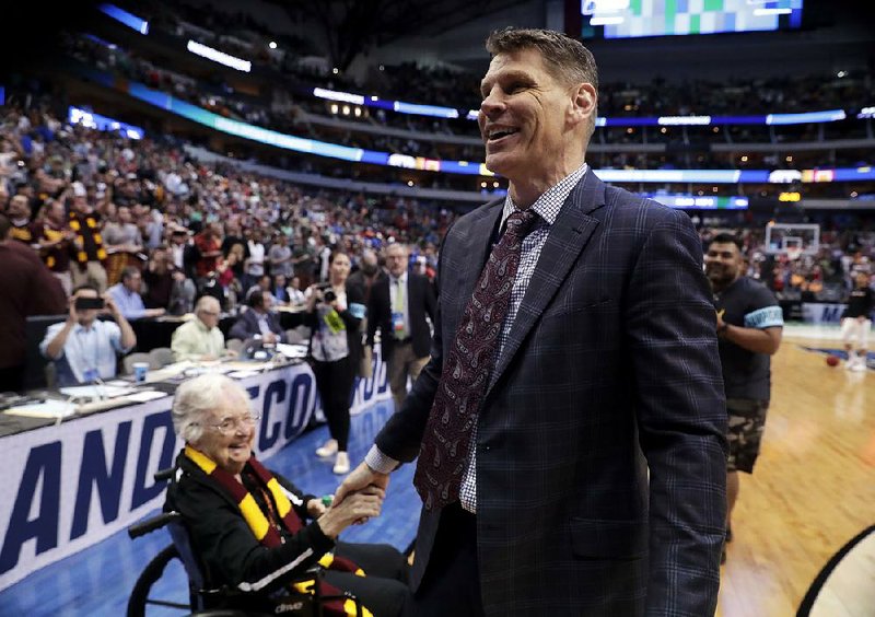 Loyola-Chicago Coach Porter Moser  is greeted by Sister Jean Dolores Schmidt (left) after the Ramblers’ 63-62 victory over  Tennessee on Saturday at the South Region of the men’s NCAA  Tournament in Dallas.
