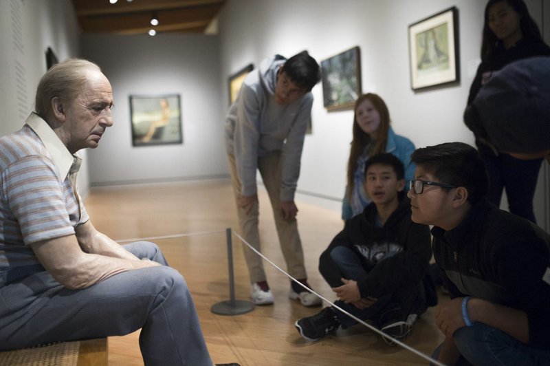 File Photo/NWA Democrat-Gazette/CHARLIE KAIJO Students from Holy Family Cathedral School of Tulsa, Okla., look at a piece called "Man on a Bench" at Crystal Bridges in Bentonville. Outside observers and local artists say Crystal Bridges has become an example for other museums and a way for people of any background to access the arts since it opened in late 2011.