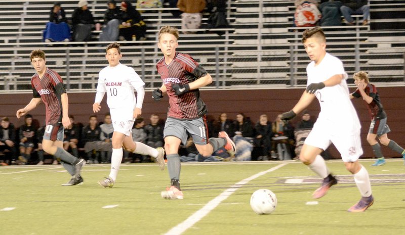Graham Thomas/Siloam Sunday Siloam Springs senior Jose Serrano dribbles in the midfield as teammate Brian Andrade, No. 10, and Owasso's Kyle Young run alongside Tuesday at Panther Stadium. The Rams defeated the Panthers 3-0.