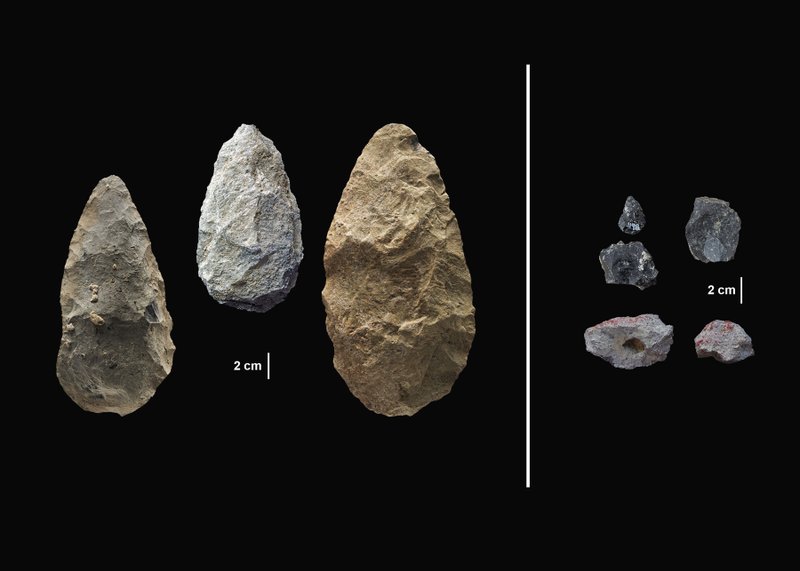 This image provided by the Smithsonian's Human Origins Program shows artifacts found in southern Kenya's Olorgesailie Basin. For hundreds of the thousands of years, people living there made and used large stone-cutting tools called handaxes, left. At right are more sophisticated tools, found in the same area, which were carefully crafted and more specialized than the large, all-purpose handaxes. (Smithsonian - Human Origins Program via AP)